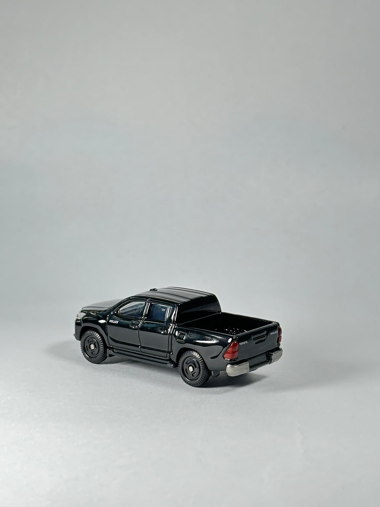 Gloss black Toyota Hilux diecast model by Takara Tomy Tomica