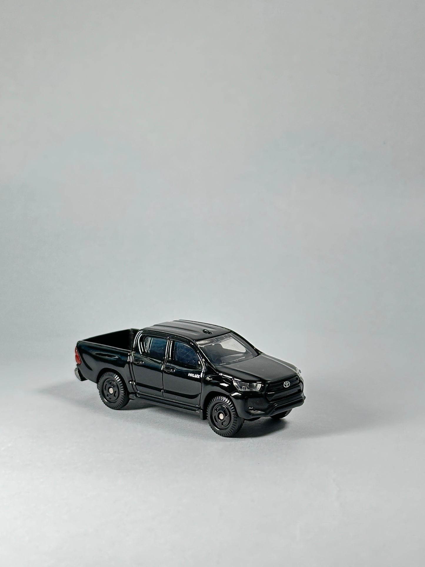 Tomica Toyota Hilux diecast truck featuring working suspension