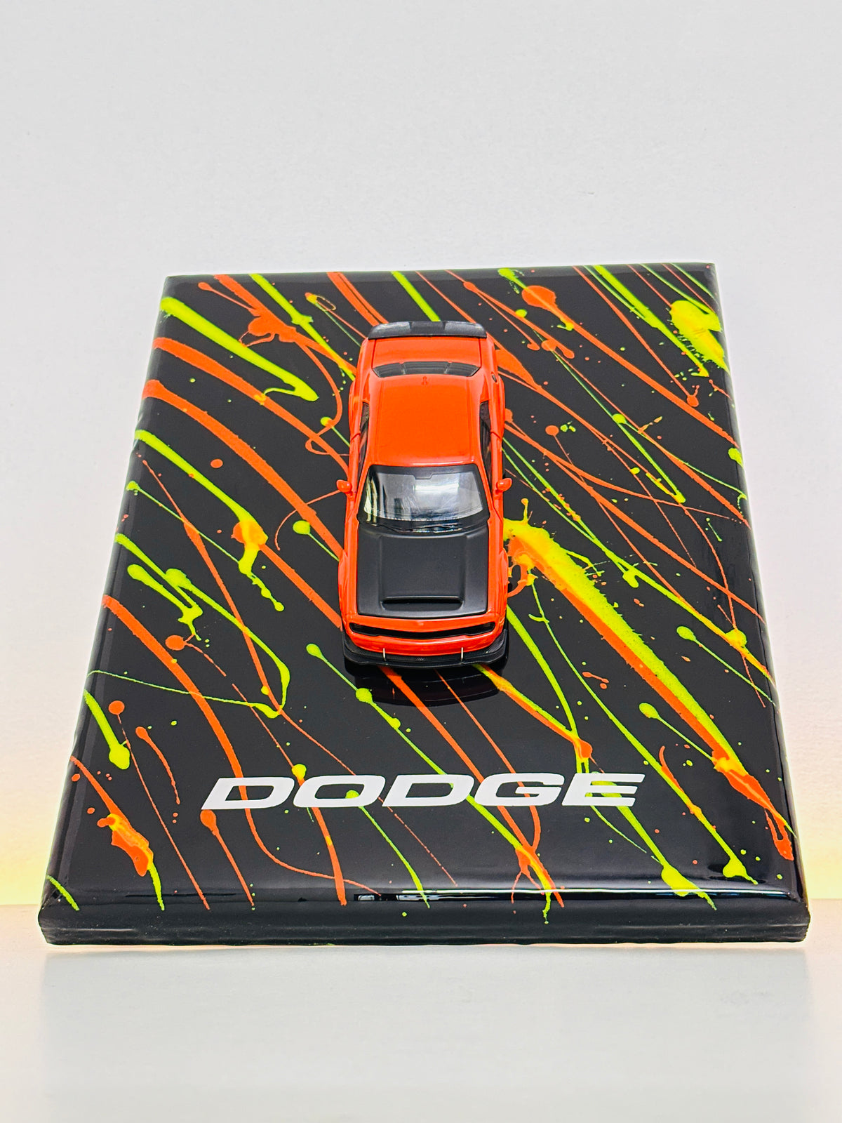 Dodge sports car diecast model displayed on custom black and orange resin plaque