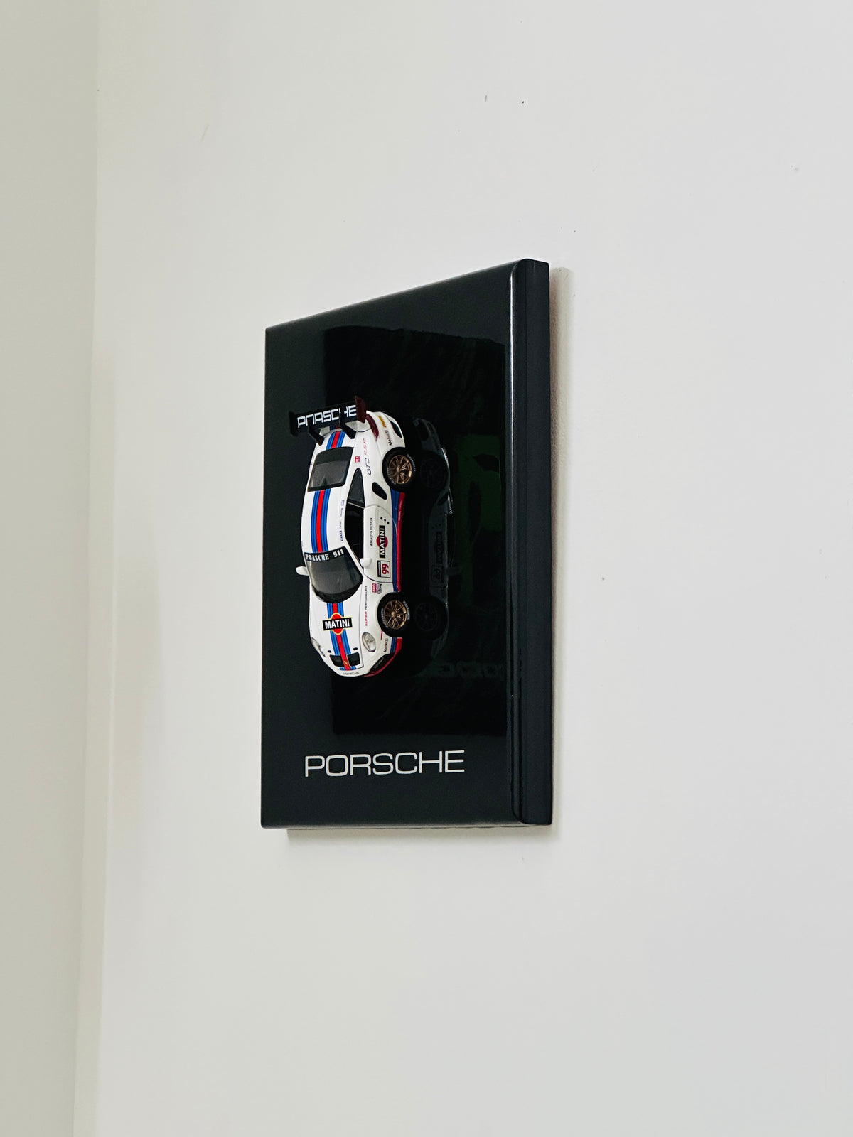 Porsche 911 racing car resin model mounted on black display frame
