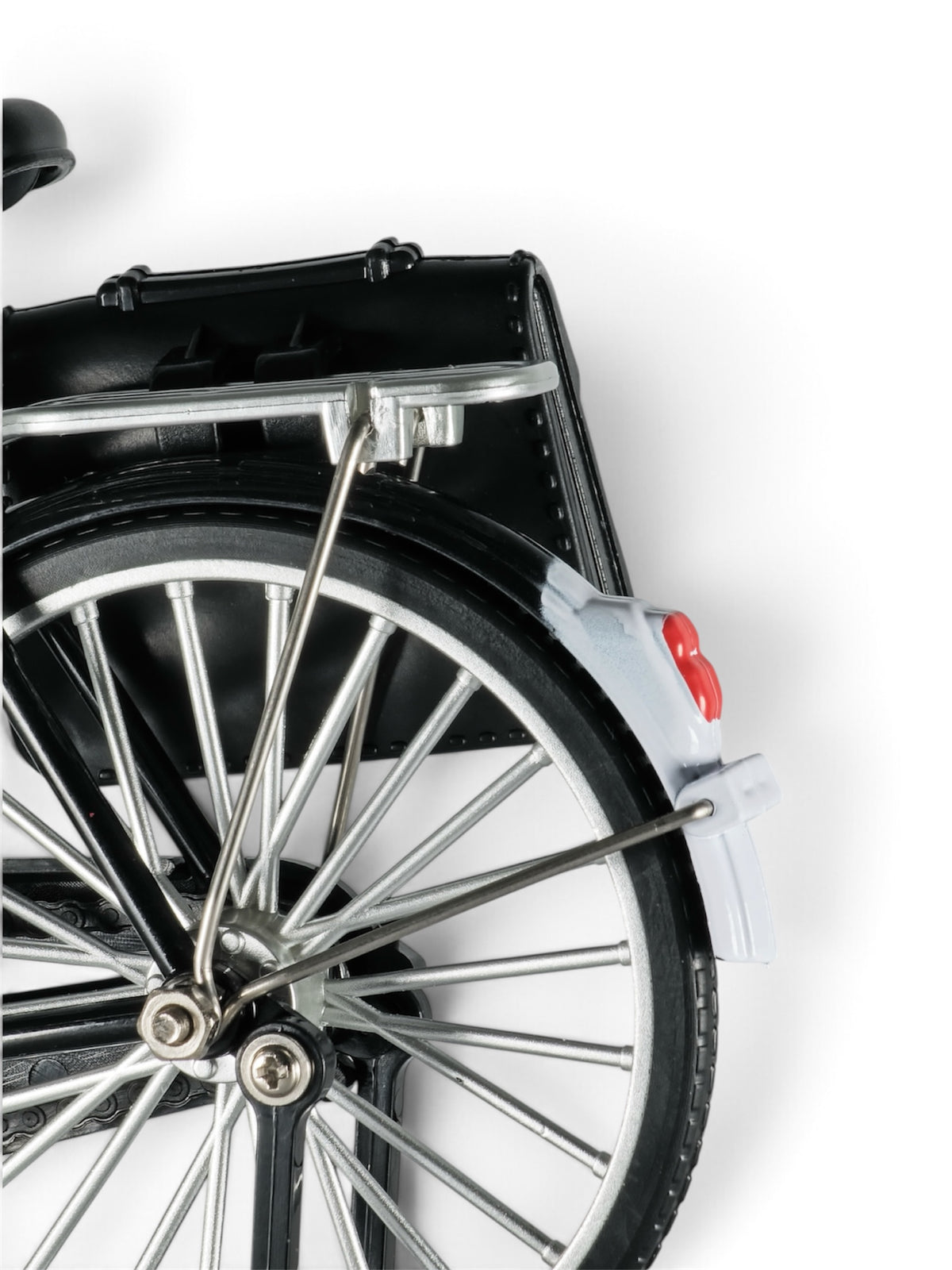 Focused on details: A small replica of a retro black bicycle resting on a kickstand, showcasing intricate chrome handlebars, pedals, and spoke wheels.