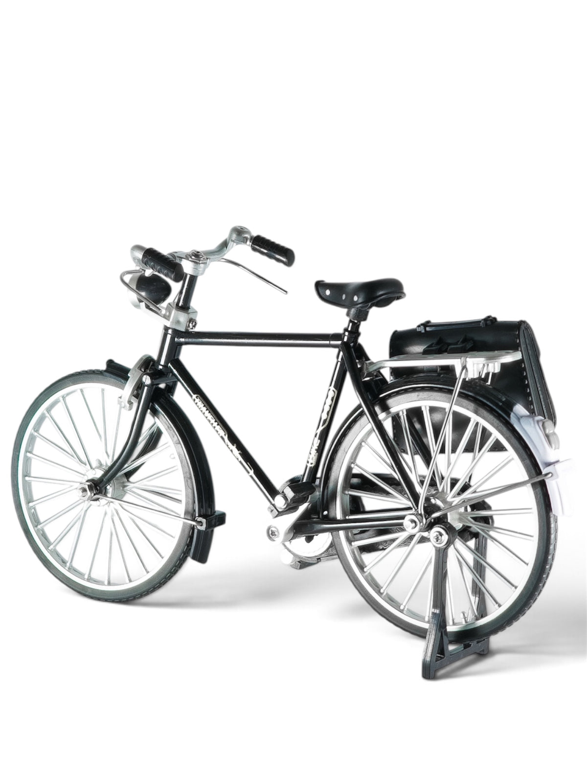 Detailed: Miniature black roadster bicycle equipped with silver rims, handlebars, a front lamp, and a black leather-style saddlebag mounted over the rear wheel rack.