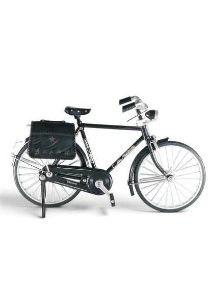  Product/e-commerce style: Miniature collectible black vintage bicycle model with attached rear luggage bag, positioned against a seamless light grey studio background.