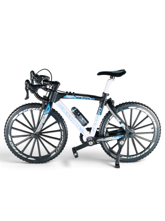 Miniature black and white road racing bicycle model displayed on a studio background.
